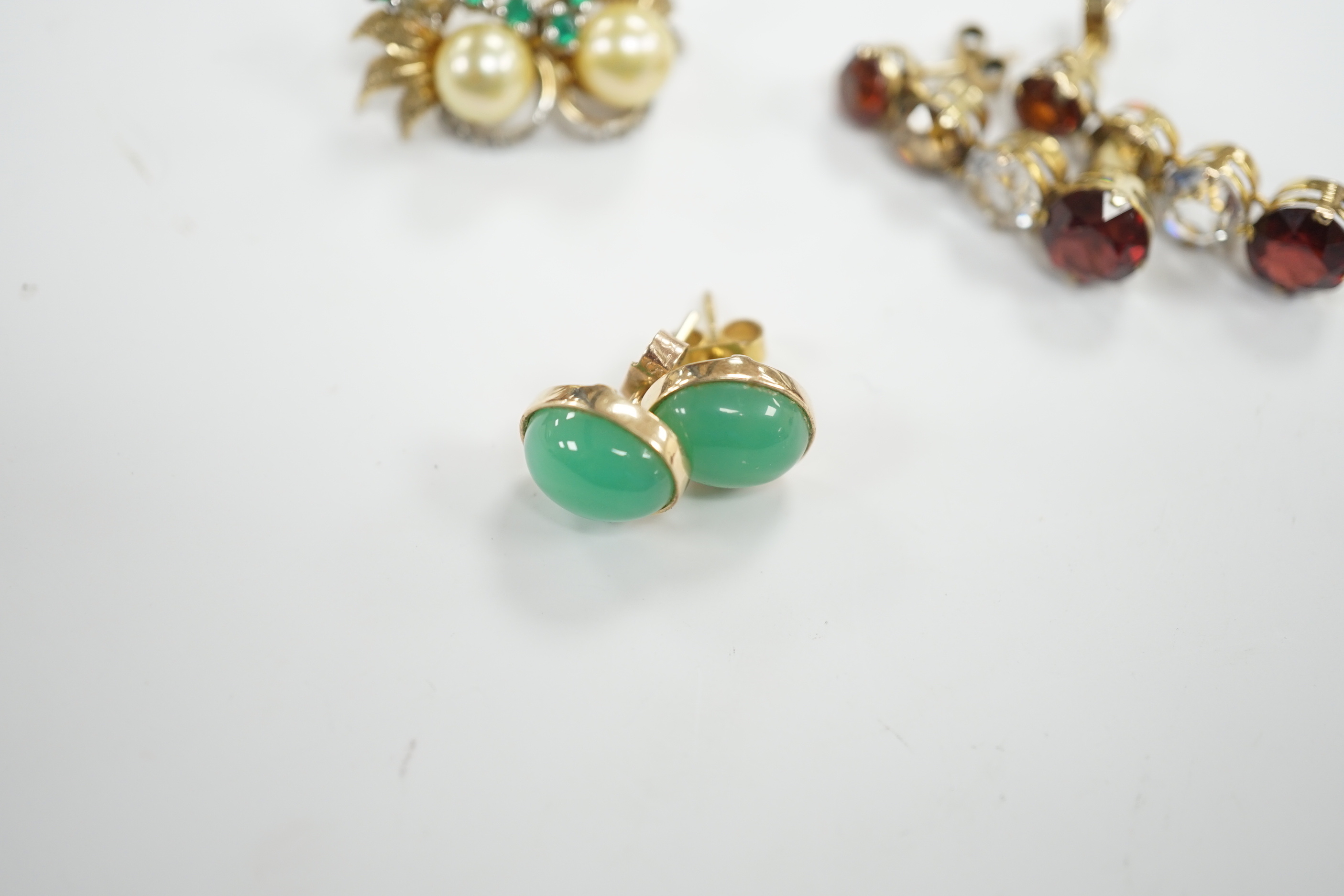 A pair of 1950’s emerald and cultured pearl cluster set earrings, 17mm, a pair of yellow metal and four stone drop earrings and a pair of cabochon chrysoprase ear studs, gross weight 10.3 grams.